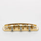 halon metric offset bridge w/ brass saddles back view gold