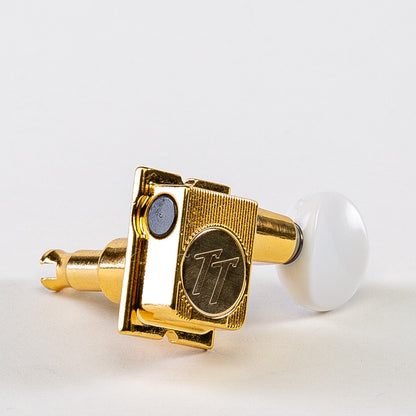 Allparts Top Tier 6 in-line keys w/ white plastic oval buttons single front view gold